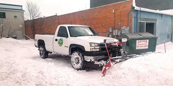 A Strand's work truck prepares to clear a clients snow covered parking lot